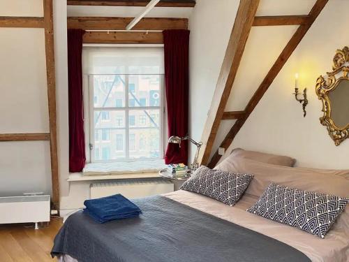 a bedroom with a bed and a window at Canal View B&B Amsterdam in Amsterdam