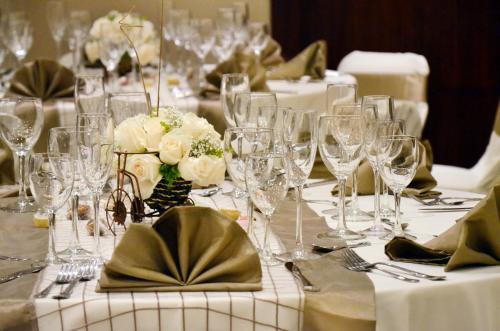 a table with wine glasses and flowers on it at Fenix Hotel in Quito