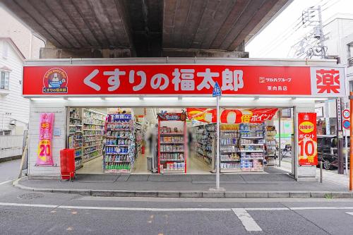 a store with a red sign on the side of a street at Bohemian Tokyo in Tokyo