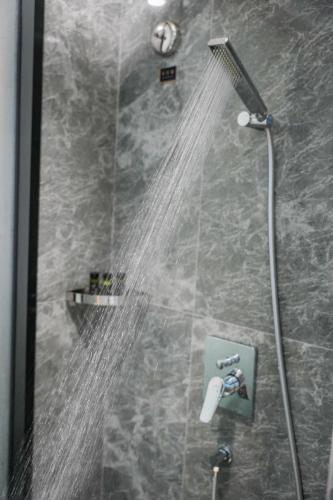 a shower with water coming out of it at Kelly Jinyue Hotel in Chengdu