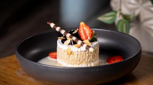 a small dessert in a black bowl on a table at Holiday Inn Santo Domingo by IHG in Santo Domingo
