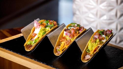a group of three hot dogs on a tray at Holiday Inn Santo Domingo by IHG in Santo Domingo