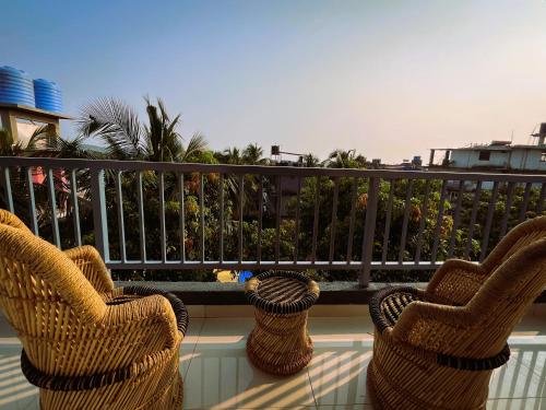 two wicker chairs sitting on top of a balcony at Arambol Bliss Hotel Apartments in Arambol