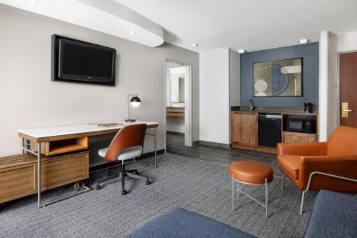 an office with a desk and a tv on a wall at Courtyard by Marriott Amarillo West/Medical Center in Amarillo