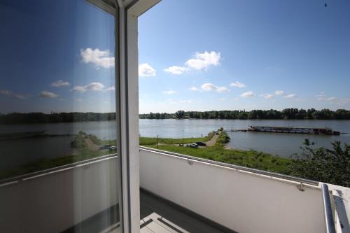 a view of a lake from a window at Fährhaus Hotel am Rhein by Mayburgh in Düsseldorf