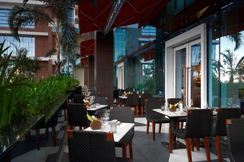 a restaurant with tables and chairs in a building at Solaire Resort Entertainment City in Manila