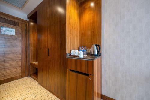 a room with a kitchen with wooden walls and a cupboard at Clarion Hotel Istanbul Mahmutbey in Istanbul