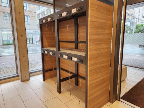 an empty cabinet in a room with wood at Comfort Hotel Naha Prefectural Office in Naha