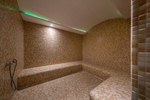 a room with a bath tub with a green light at Clarion Hotel Istanbul Mahmutbey in Istanbul