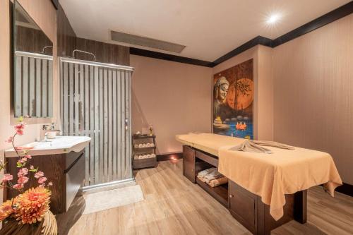 a hospital room with a bed and a sink at Clarion Hotel Istanbul Mahmutbey in Istanbul