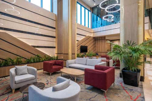 a lobby with chairs and a tv in a building at Clarion Hotel Golden Horn in Istanbul