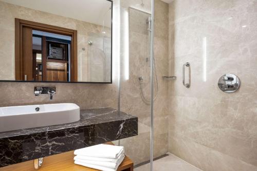 a bathroom with a sink and a shower at Clarion Hotel Golden Horn in Istanbul