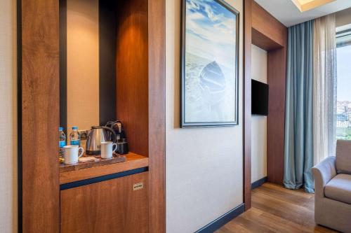 a corridor of a room with a door with a counter at Clarion Hotel Golden Horn in Istanbul