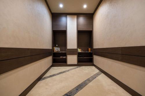 a hallway with brown and white walls and a pillar at Clarion Hotel Golden Horn in Istanbul