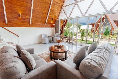 a living room with a couch and a table at Svargan Lakeside Glamping in Tabanan