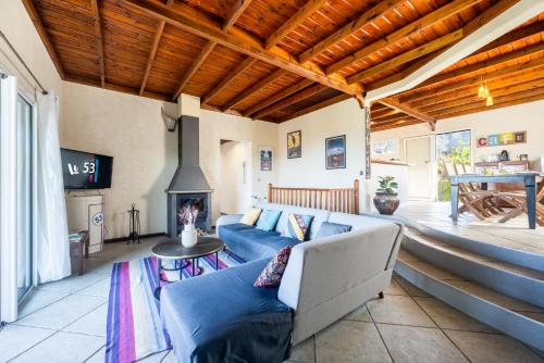 a living room with a couch and a fireplace at Le 53-LES MAKES in Saint-Louis