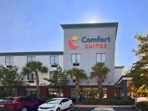 a hotel with cars parked in front of it at Comfort Suites Mobile-South Alabama University Area in Mobile
