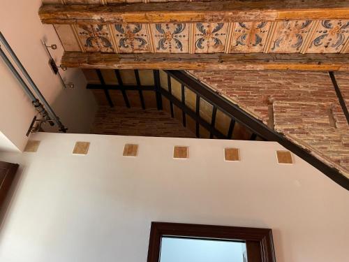 an attic room with a wooden ceiling and a window at Daniel's Winter in Palermo