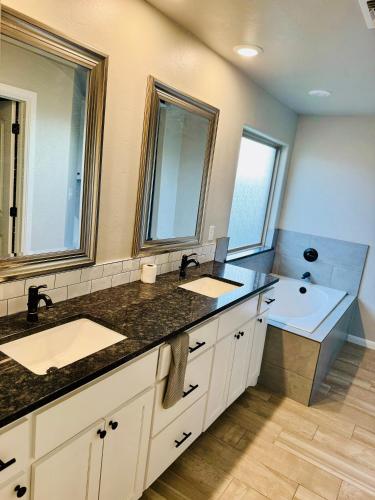 a bathroom with two sinks and a large mirror at A place like nowhere else in Lawton