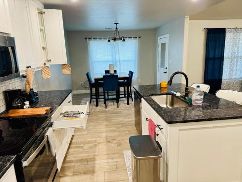 a kitchen with a sink and a table in a room at A place like nowhere else in Lawton