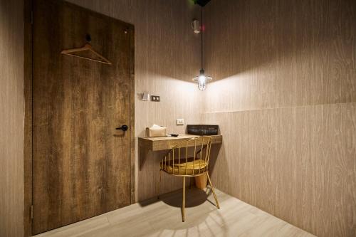 a room with a table and a door and a chair at York Hotel in Taipei