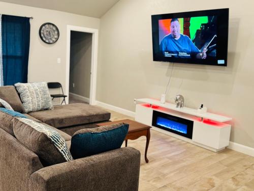 a living room with a couch and a tv on the wall at A place like nowhere else in Lawton