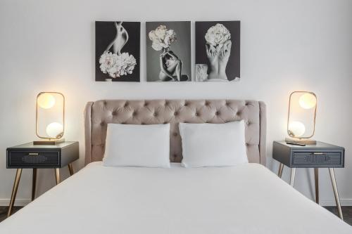 a bedroom with a white bed with two night stands at Sunset Flat in Oradea