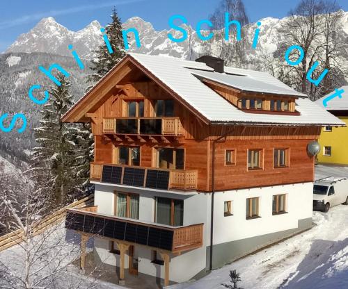 a house in the mountains with snow on the ground at Chalet Leni in Schladming