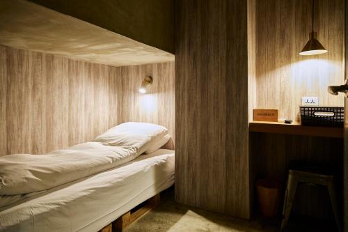a room with a bed in the corner of a room at York Hotel in Taipei