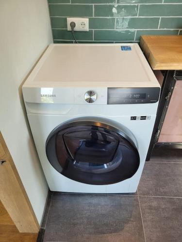 a washing machine in a corner of a room at luxury house between the windmills in old center in Winsum