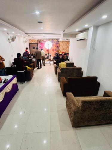 a waiting room with couches and people sitting in chairs at Hotel 51 in Amritsar