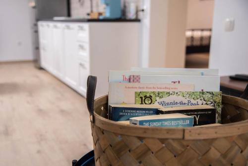 a basket full of books sitting in a room at Green Street Hideaway in Šempeter v Savinjski Dolini