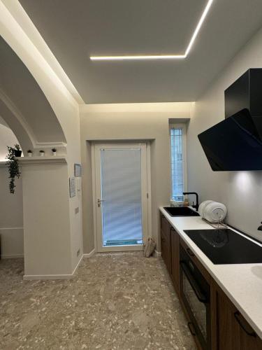 a kitchen with a sink and a counter top at Tosini's Home in Sale Marasino