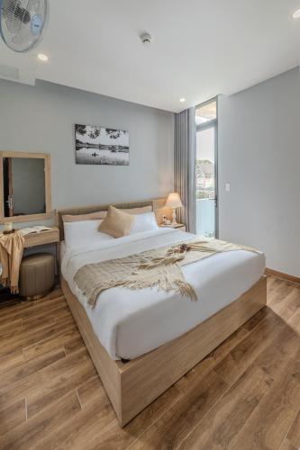 a bedroom with a large bed and a television at Gia Nguyễn Hotel Dalat in Da Lat