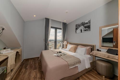 a bedroom with a large bed and a large window at Gia Nguyễn Hotel Dalat in Da Lat