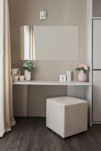 a room with a table with a ottoman and a window at Hotel Ca' Bianca in Riccione