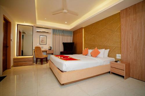 a hotel room with a bed and a desk at Royal Raj Hotel in Rājshāhi