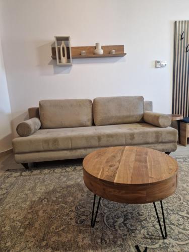 a living room with a couch and a coffee table at MELATO HOUSES in Valtessiniko 