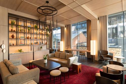 a living room with a couch and a table at Adelaide Marriott Hotel in Adelaide