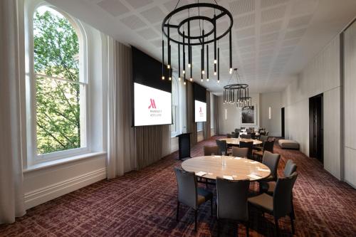 a dining room with a table and chairs at Adelaide Marriott Hotel in Adelaide