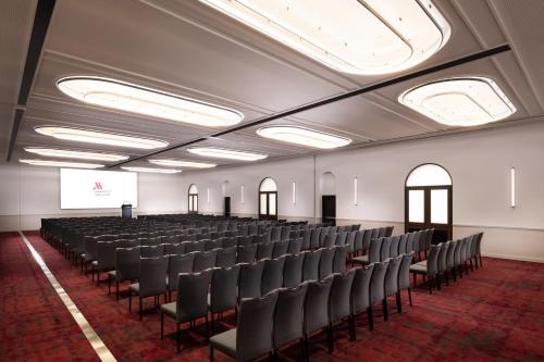 a large room with chairs and a screen in it at Adelaide Marriott Hotel in Adelaide
