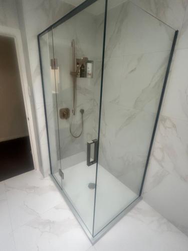 a shower with a glass enclosure in a bathroom at Manorburn Apartments Luxury Studio Apartment Central Otago in Ranfurly