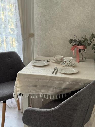 une table avec un chiffon de table blanc et des assiettes dessus dans l'établissement Anahit, à Nice