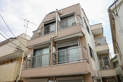 an apartment building with balconies on the side of it at ハイクレスト中野202 in Tokyo