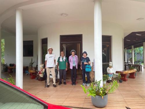 a group of people standing in front of a house at Suzukis lagoon front in Katunayake