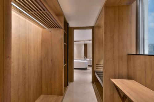 a bathroom with wood paneling and a bath tub at The Westin Mumbai Powai Lake in Mumbai