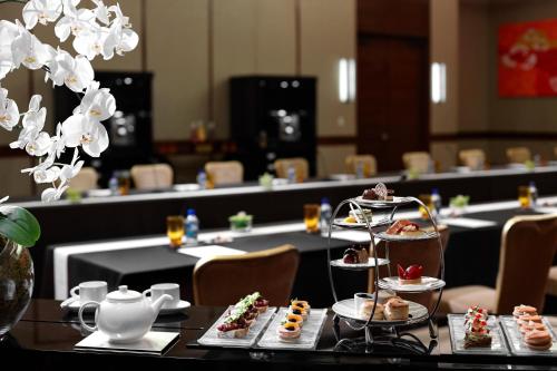 a table with several plates of food on top at Solaire Resort Entertainment City in Manila