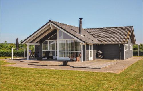 a small house with a large deck in a field at Holiday Home Askemose Sydals Xi in Skovby