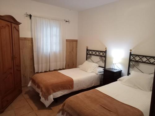 Postel nebo postele na pokoji v ubytování Casas El Barrancón