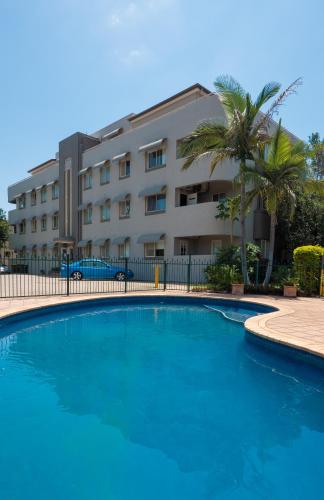 a large swimming pool in front of a building at Hampton Court Apartments in Brisbane
